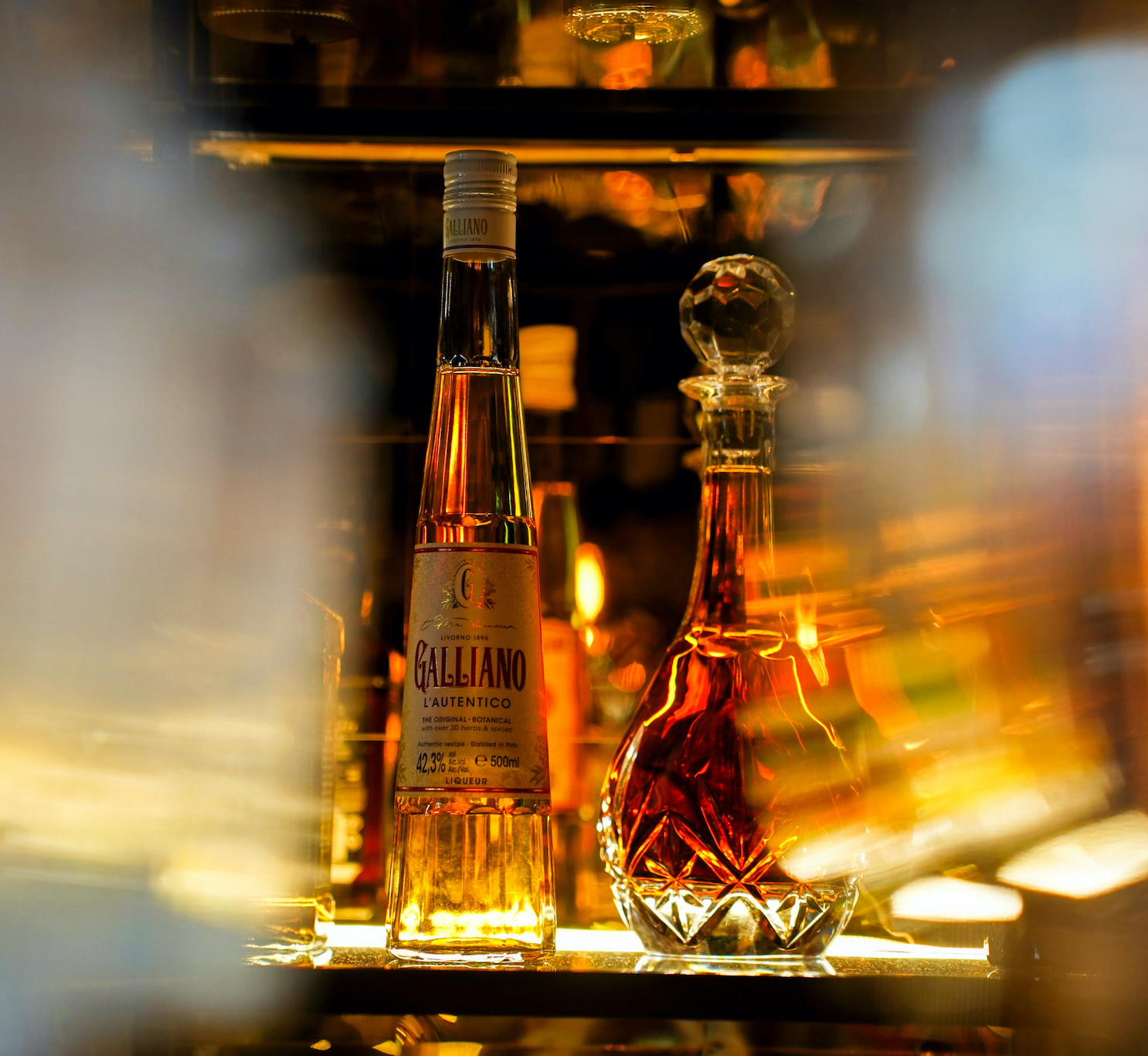 Bottles on the bar between glasses